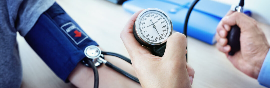 Doctor checking the blood pressure of a patient