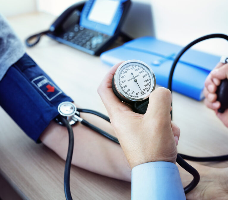 Doctor checking the blood pressure of a patient